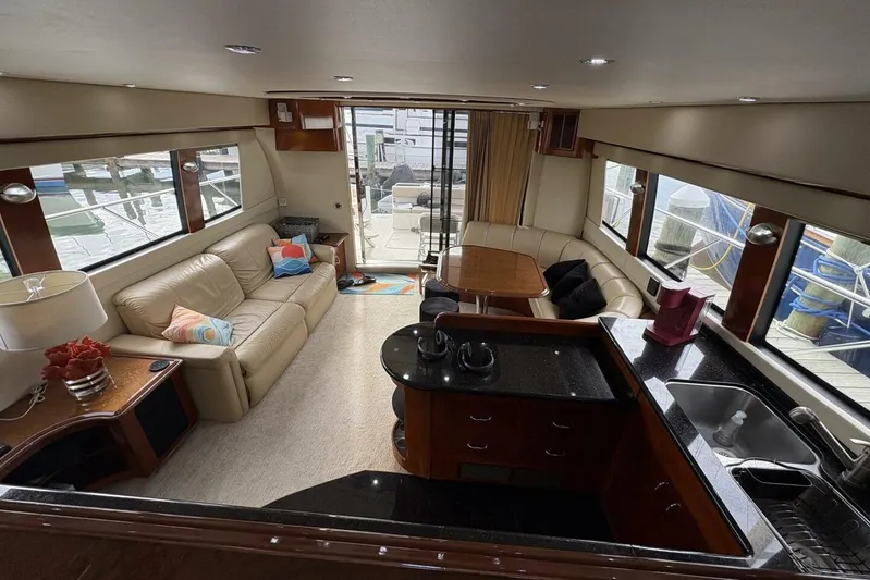 Carlet Vivian IV Yacht Photos Pics Luxurious interior of 2004 Carver 56 Voyager yacht with elegant seating and modern kitchen.