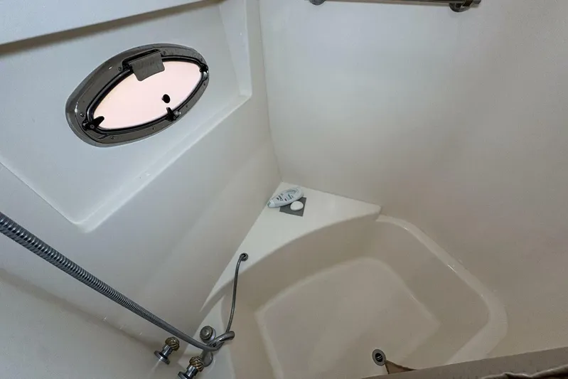 Carlet Vivian IV Yacht Photos Pics 2004 Carver 56 Voyager yacht bathroom with shower and porthole window.