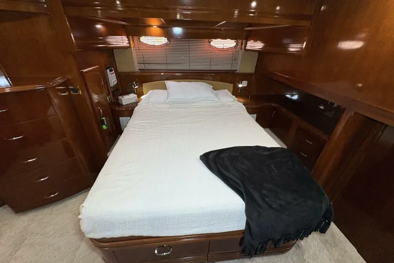 Carlet Vivian IV Yacht Photos Pics Luxurious bedroom interior of 2004 Carver 56 Voyager yacht with wooden cabinetry.