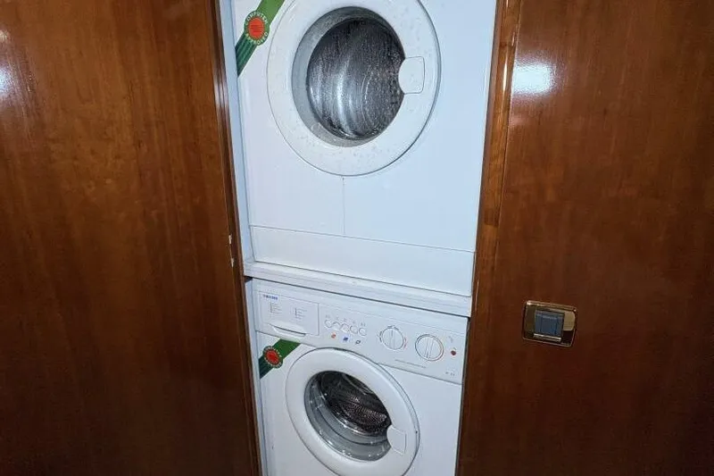 Carlet Vivian IV Yacht Photos Pics Stacked washer and dryer in 2004 Carver 56 Voyager yacht interior.