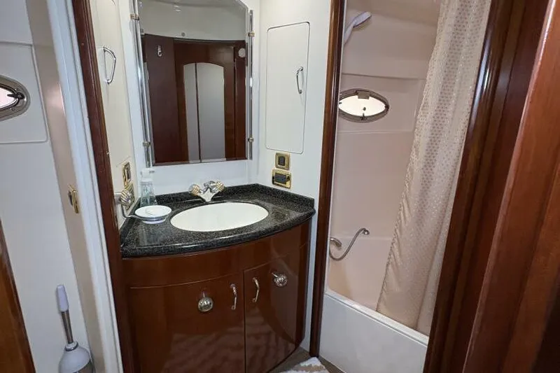 Carlet Vivian IV Yacht Photos Pics Luxurious bathroom in 2004 Carver 56 Voyager yacht with elegant wood cabinetry.