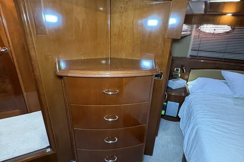 Carlet Vivian IV Yacht Photos Pics Luxurious 2004 Carver 56 Voyager bedroom with wooden cabinetry and cozy bed.
