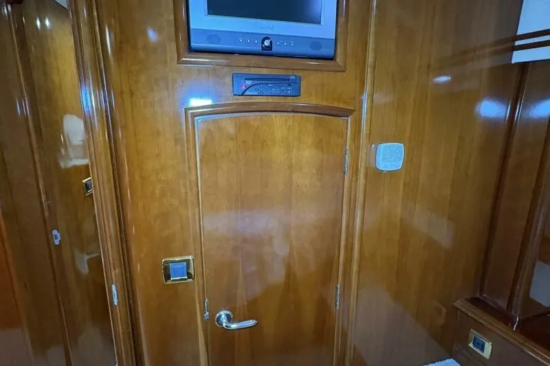 Carlet Vivian IV Yacht Photos Pics Interior of 2004 Carver 56 Voyager with wooden door and mounted TV.
