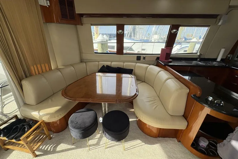 Carlet Vivian IV Yacht Photos Pics Luxurious interior of 2004 Carver 56 Voyager yacht with leather seating and wooden table.
