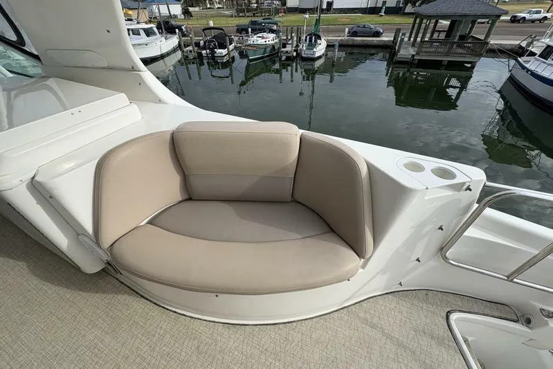 Carlet Vivian IV Yacht Photos Pics 2004 Carver 56 Voyager yacht with beige seating and cup holders, docked at marina.