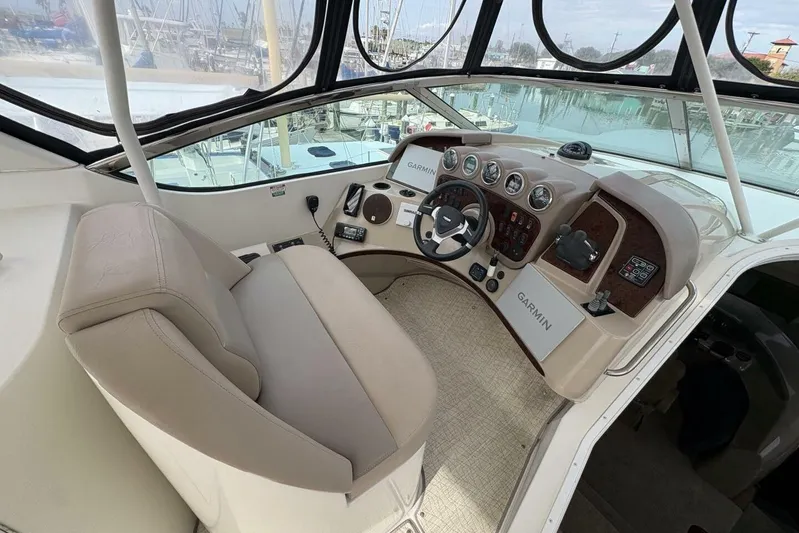 Carlet Vivian IV Yacht Photos Pics 2004 Carver 56 Voyager helm with Garmin navigation, beige seating, and panoramic marina view.