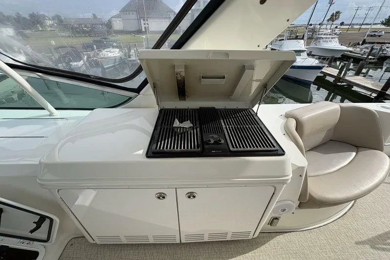Carlet Vivian IV Yacht Photos Pics Outdoor grill on 2004 Carver 56 Voyager yacht, with seating and marina view.