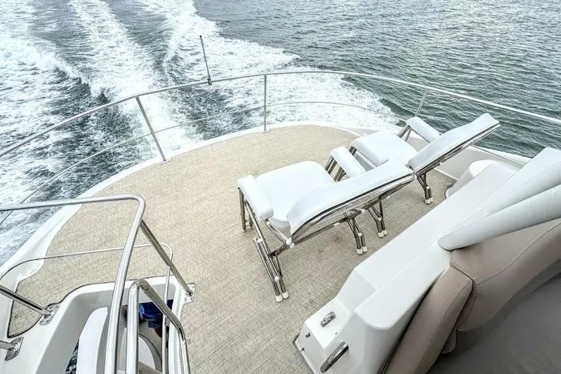 Carlet Vivian IV Yacht Photos Pics 2004 Carver 56 Voyager yacht deck with lounge chairs, cruising on open water.