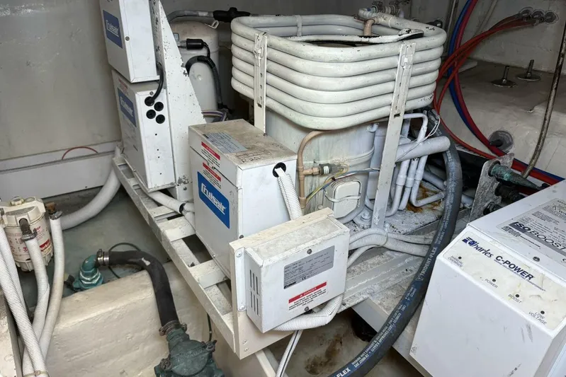 Carlet Vivian IV Yacht Photos Pics Engine room of a 2004 Carver 56 Voyager with mechanical components and wiring.