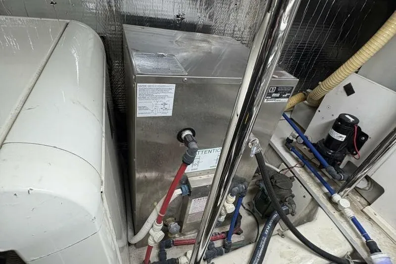 Carlet Vivian IV Yacht Photos Pics Engine room of 2004 Carver 56 Voyager yacht with mechanical equipment and piping.