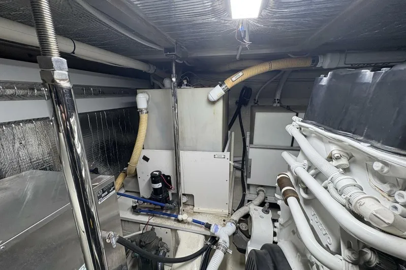 Carlet Vivian IV Yacht Photos Pics Engine room of a 2004 Carver 56 Voyager yacht, showcasing mechanical components and piping.