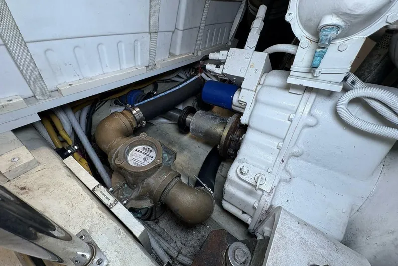 Carlet Vivian IV Yacht Photos Pics Engine compartment of a 2004 Carver 56 Voyager yacht, showcasing mechanical components and piping.