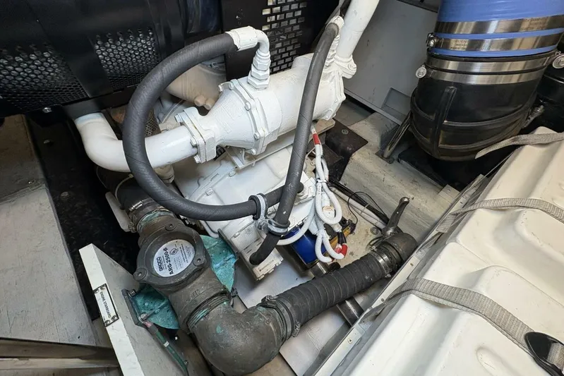 Carlet Vivian IV Yacht Photos Pics Engine compartment of a 2004 Carver 56 Voyager yacht, showcasing mechanical components and piping.