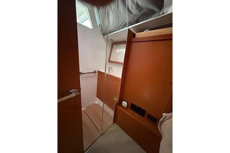  Yacht Photos Pics Interior of 2013 Beneteau Sense 46 yacht, featuring wooden cabinetry and compact design.