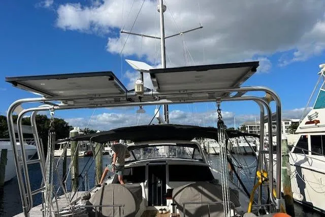  Yacht Photos Pics 2013 Beneteau Sense 46 yacht docked, featuring solar panels and a clear blue sky.