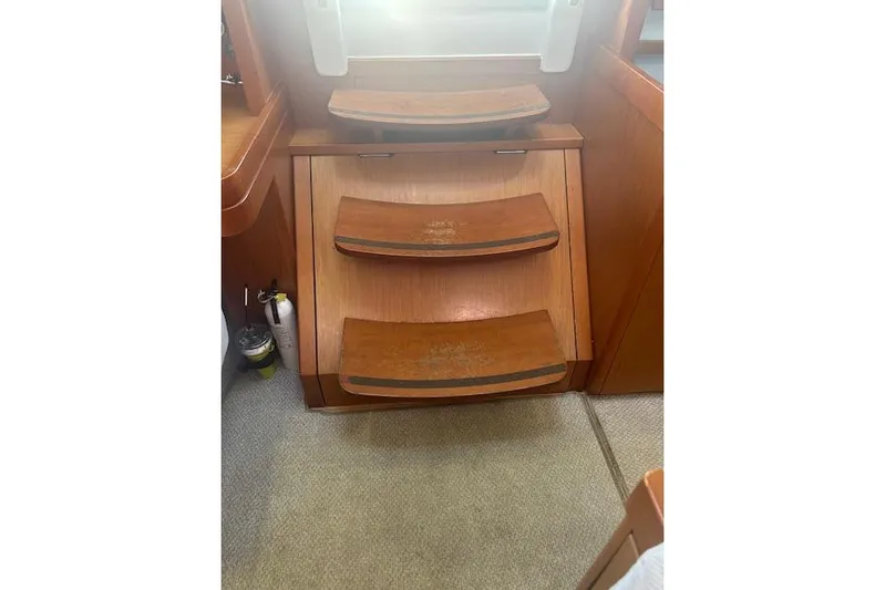  Yacht Photos Pics Wooden steps inside a 2013 Beneteau Sense 46 yacht, showcasing elegant interior design.