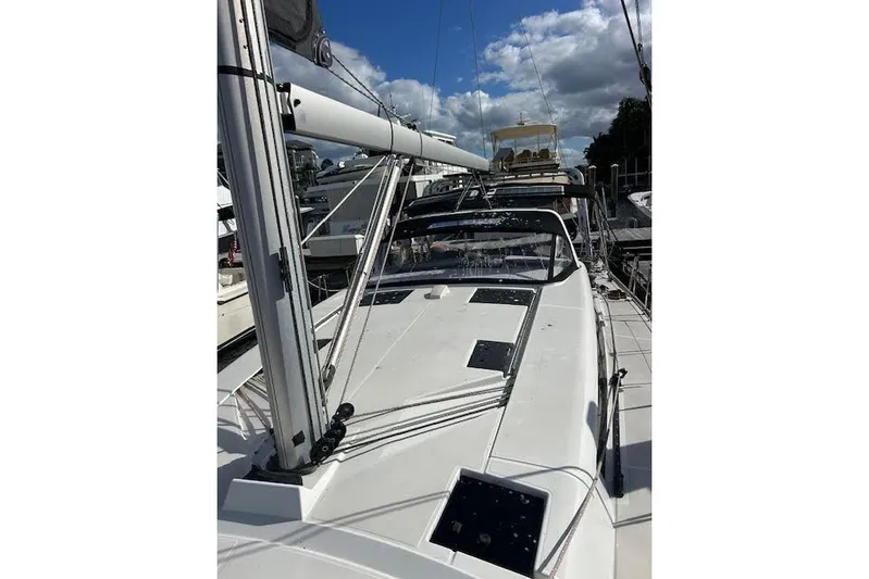  Yacht Photos Pics 2013 Beneteau Sense 46 sailboat docked, showcasing sleek deck design under a blue sky.