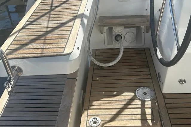  Yacht Photos Pics 2013 Beneteau Sense 46 yacht deck with wooden flooring and steering wheel.