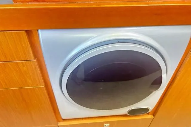  Yacht Photos Pics Built-in washing machine on 2013 Beneteau Sense 46 yacht, wooden cabinetry.