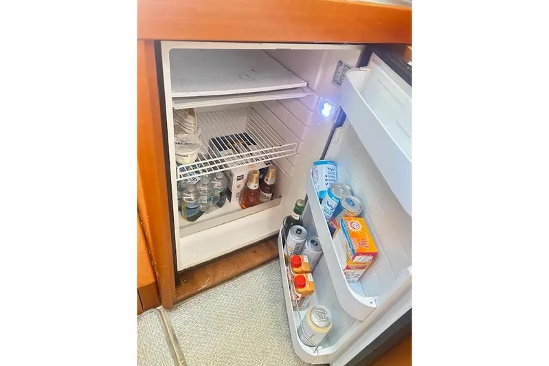 Yacht Photos Pics Open fridge on 2013 Beneteau Sense 46 yacht, stocked with beverages and snacks.
