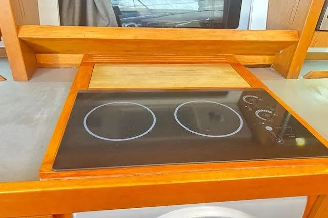  Yacht Photos Pics Modern kitchen stove in 2013 Beneteau Sense 46 yacht, featuring a sleek two-burner cooktop.