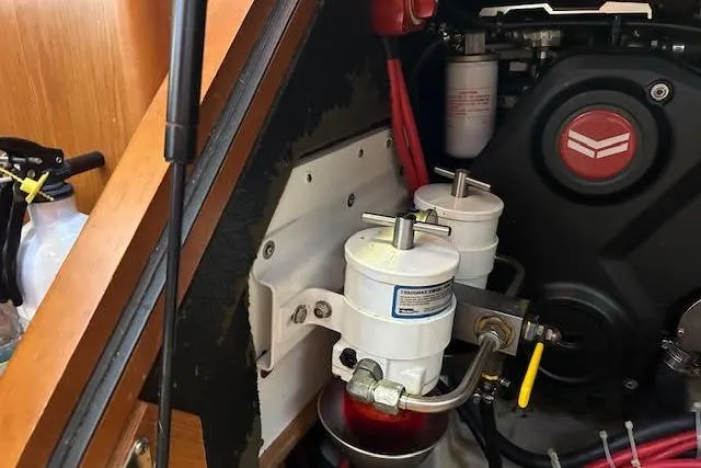  Yacht Photos Pics Engine compartment of a 2013 Beneteau Sense 46 sailboat, showcasing fuel filters and engine components.