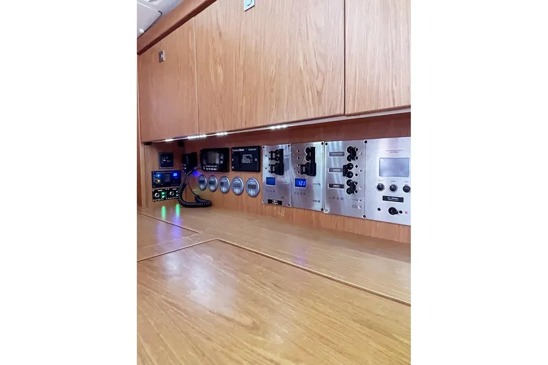  Yacht Photos Pics Control panel of a 2013 Beneteau Sense 46 yacht with wooden cabinetry.