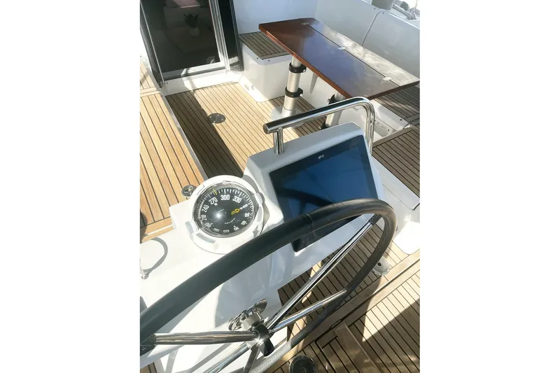  Yacht Photos Pics Steering wheel and navigation instruments on 2013 Beneteau Sense 46 yacht deck.