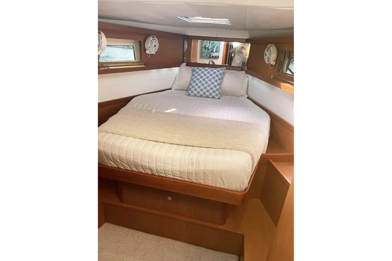  Yacht Photos Pics Cozy bedroom interior of 2013 Beneteau Sense 46 yacht with elegant wood finish.