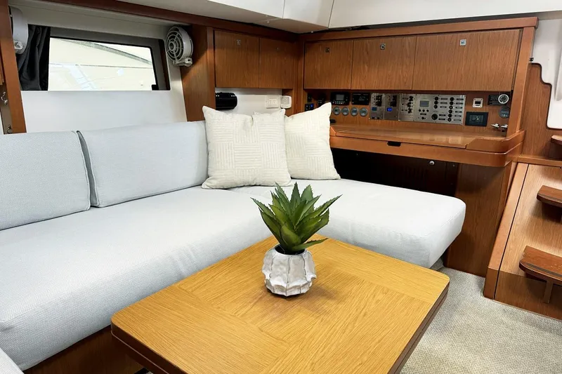  Yacht Photos Pics Luxurious interior of 2013 Beneteau Sense 46 yacht with modern seating and control panel.