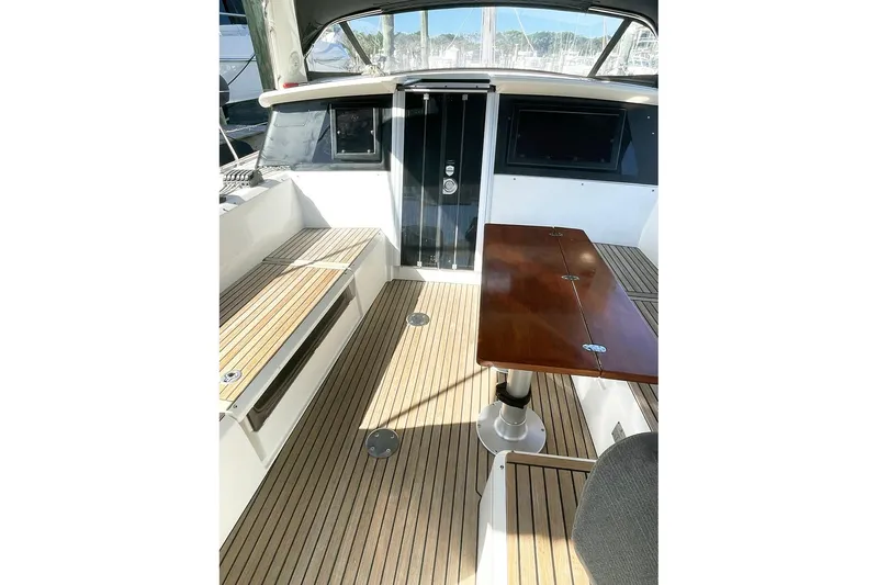 Yacht Photos Pics 2013 Beneteau Sense 46 yacht cockpit with wooden table and seating.