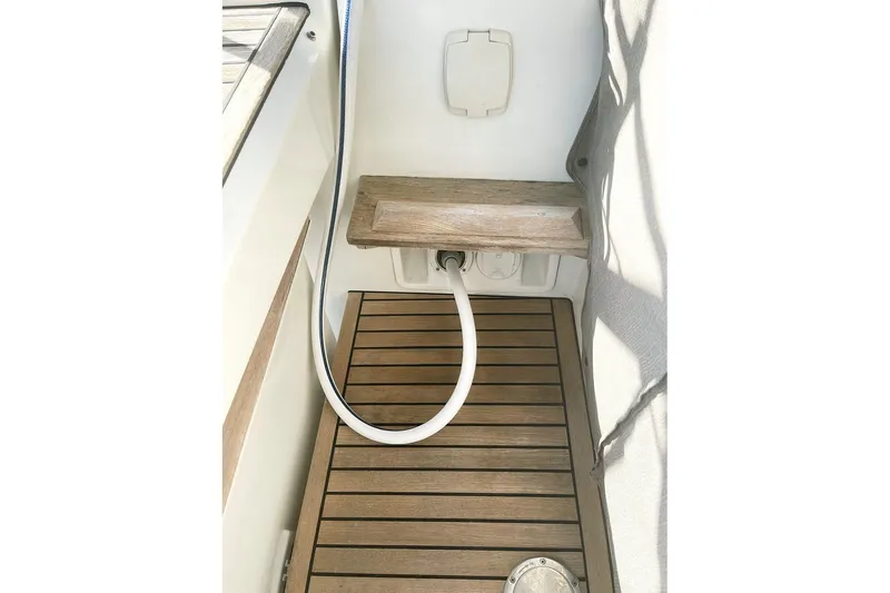  Yacht Photos Pics Teak deck and hose on 2013 Beneteau Sense 46 sailboat.