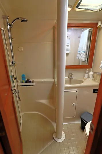  Yacht Photos Pics 2000 Riviera Flybridge Convertible bathroom with shower, sink, and mirror.