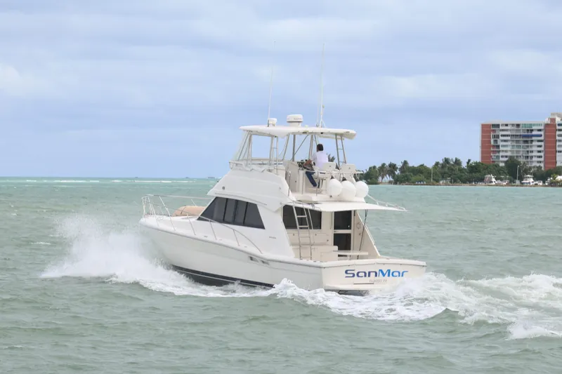  Yacht Photos Pics 2000 Riviera Flybridge Convertible yacht cruising on open water.