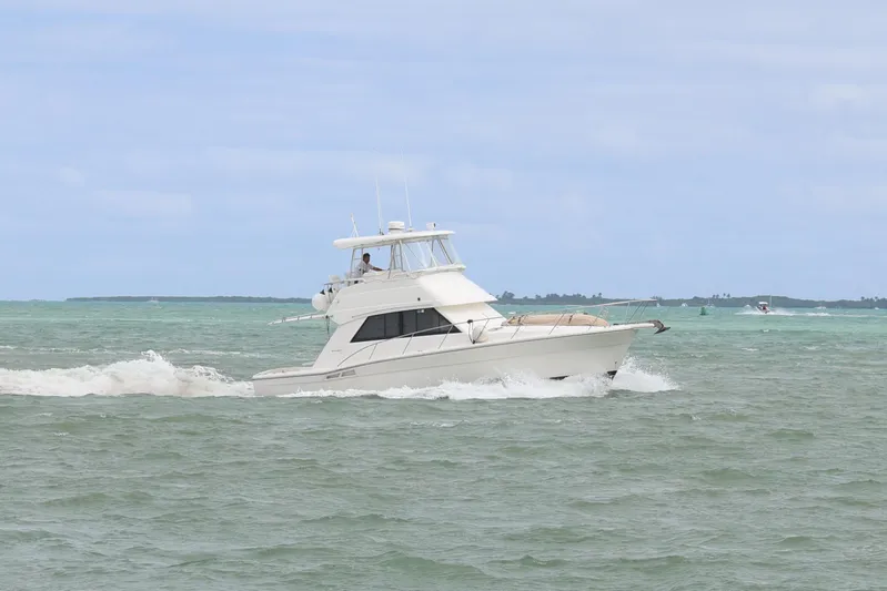  Yacht Photos Pics 2000 Riviera Flybridge Convertible cruising on open water.