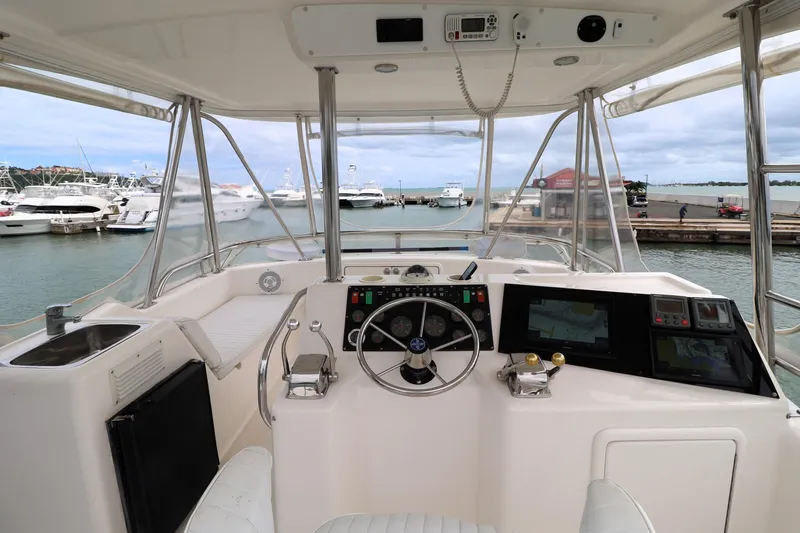  Yacht Photos Pics Helm of 2000 Riviera Flybridge Convertible yacht with marina view.