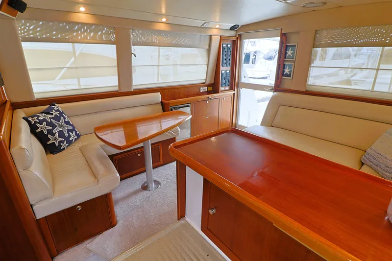  Yacht Photos Pics Luxurious interior of 2000 Riviera Flybridge Convertible yacht with elegant wood finishes.