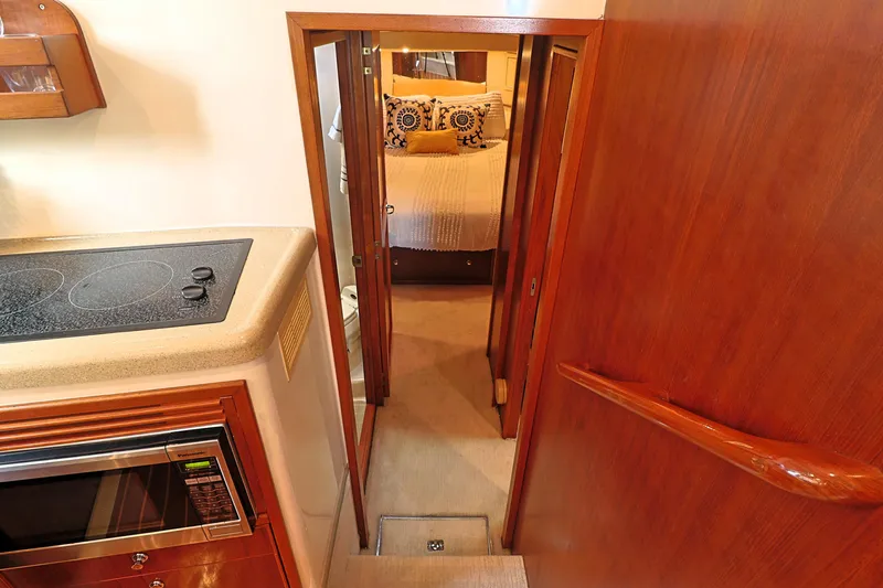  Yacht Photos Pics Interior of 2000 Riviera Flybridge Convertible yacht with kitchen and bedroom view.