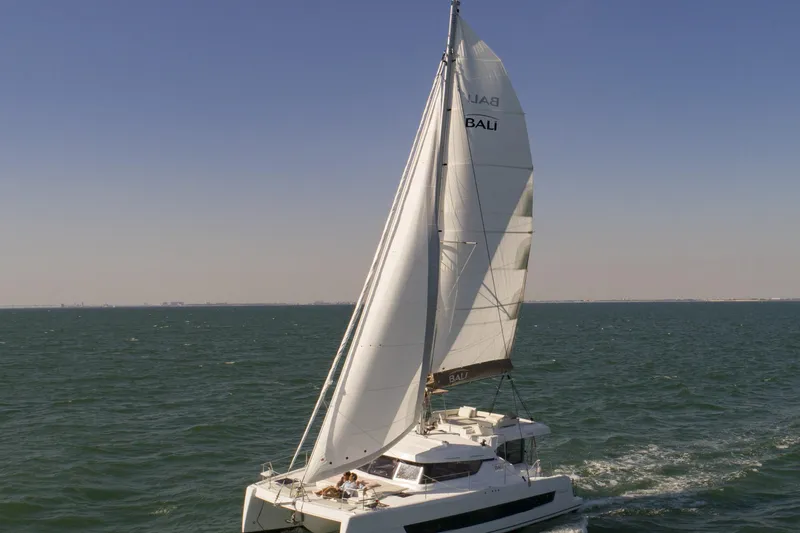 Yacht Photos Pics 2026 Bali CATSPACE catamaran sailing on open sea under clear blue sky.