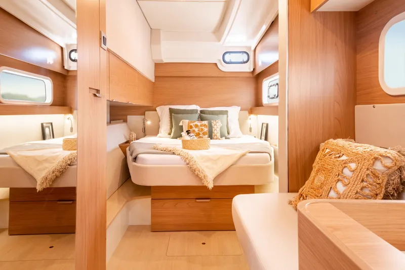  Yacht Photos Pics Luxurious 2026 Bali CATSPACE yacht interior with cozy bedroom and elegant wooden finishes.
