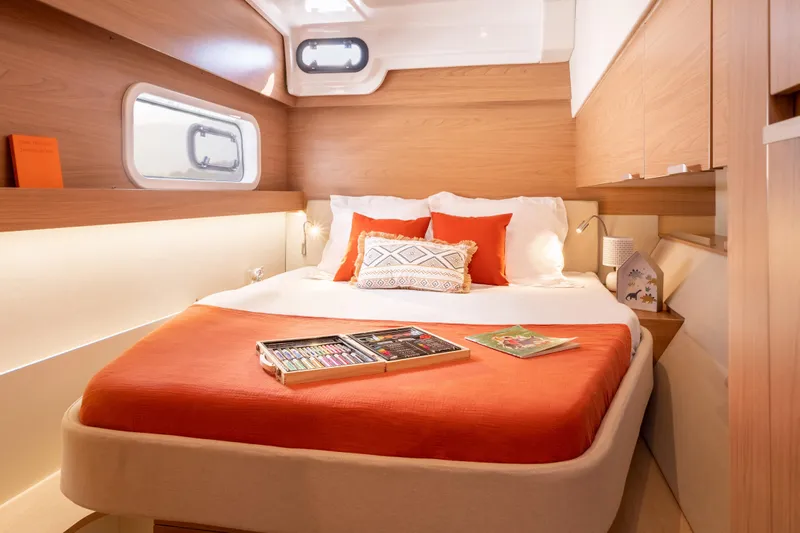  Yacht Photos Pics Luxurious 2026 Bali CATSPACE yacht cabin with cozy bed and vibrant orange accents.