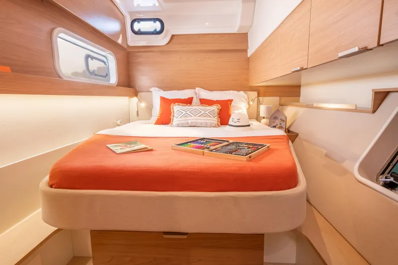  Yacht Photos Pics Luxurious 2026 Bali CATSPACE yacht cabin with cozy bed and modern wooden interior design.