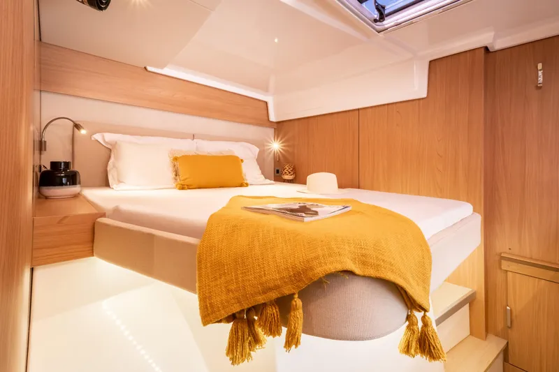  Yacht Photos Pics Luxurious cabin interior of 2026 Bali CATSPACE yacht with cozy bed and warm lighting.