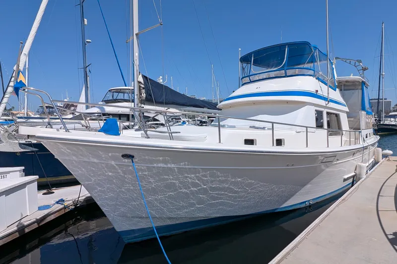 Fishers Folly IV Yacht Photos Pics 1988 Offshore Yachts 48 Yachtfisher docked at marina under clear blue sky.