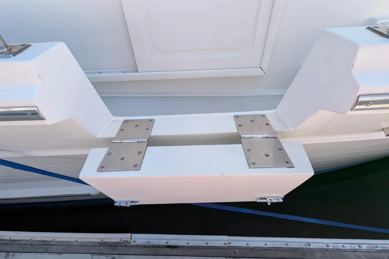 Fishers Folly IV Yacht Photos Pics Boarding platform of 1988 Offshore Yachts 48 Yachtfisher, featuring sturdy hinges and sleek design.