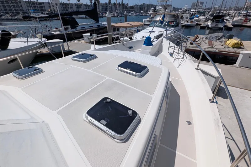 Fishers Folly IV Yacht Photos Pics 1988 Offshore Yachts 48 Yachtfisher docked in marina, showcasing deck and hatches.