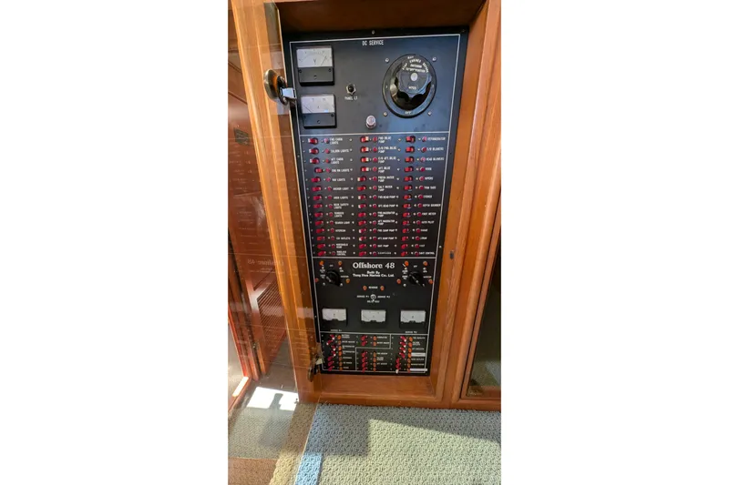 Fishers Folly IV Yacht Photos Pics Electrical panel of 1988 Offshore Yachts 48 Yachtfisher, featuring switches and gauges.