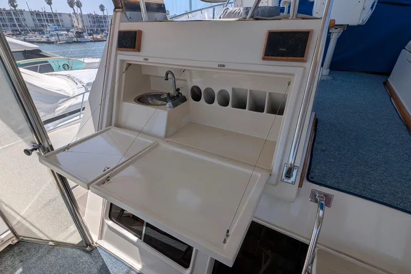 Fishers Folly IV Yacht Photos Pics 1988 Offshore Yachts 48 Yachtfisher interior with sink and storage compartments.