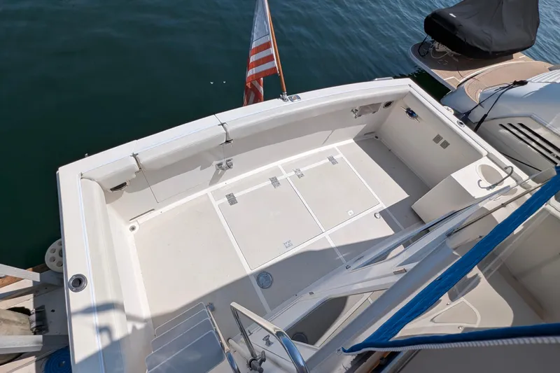 Fishers Folly IV Yacht Photos Pics 1988 Offshore Yachts 48 Yachtfisher deck with American flag, spacious and clean layout.