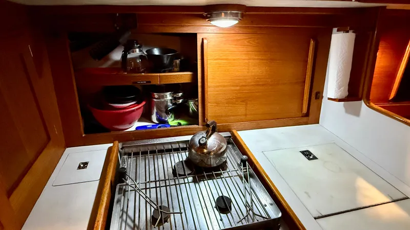 Elan Yacht Photos Pics 1989 J Boats J/40 yacht galley with stove, kettle, and wooden cabinetry.